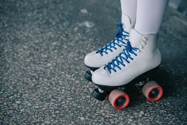 partial view of woman in white high socks and retro roller skates - 写真・画像