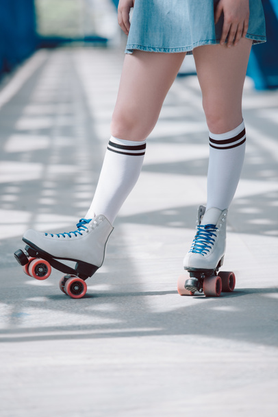 partial view of woman in white high socks with black stripes and retro roller skates - Valokuva, kuva