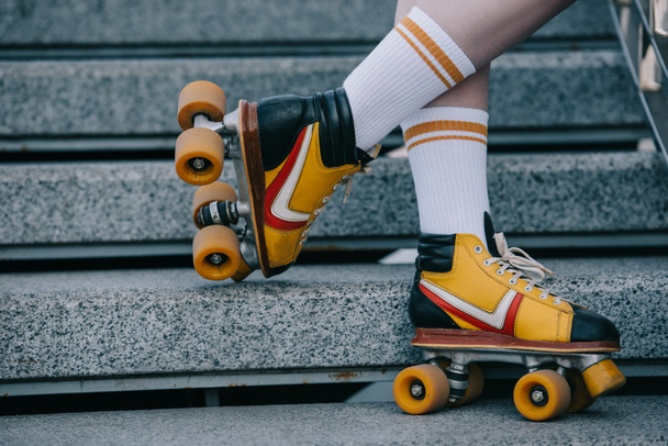 cropped shot of girl on girl wearing roller skates on street - Photo, Image
