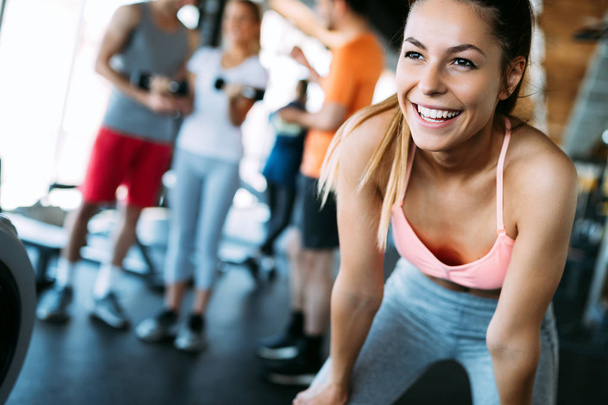 Close up image of smiling attractive fit woman in gym - Fotó, kép