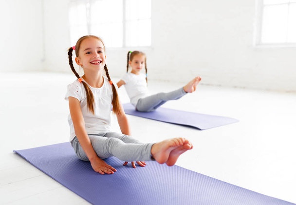 children girls doing yoga and gymnastics in the gy - Photo, Image