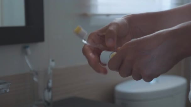 Young woman brushing teeth with a tooth brush in bathroom - Filmagem, Vídeo