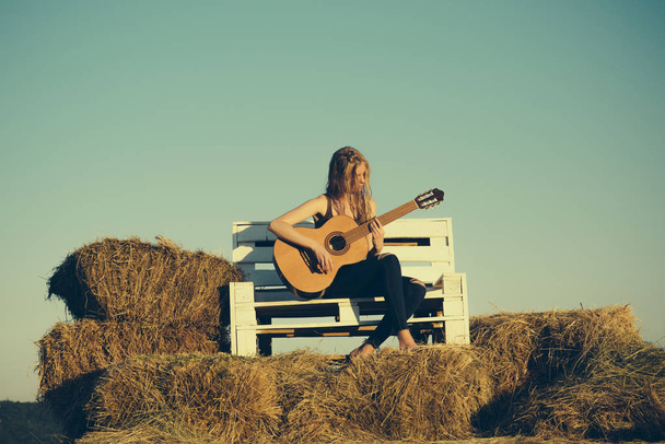 Musician play acoustic guitar on sunny nature. Musician perform music concert on guitar, string instrument. - Foto, Imagem