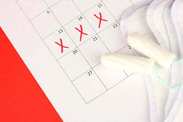 menstruation calendar with sanitary pads and tampons, close-up - Valokuva, kuva