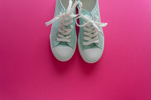 sneakers on pink background - Фото, изображение