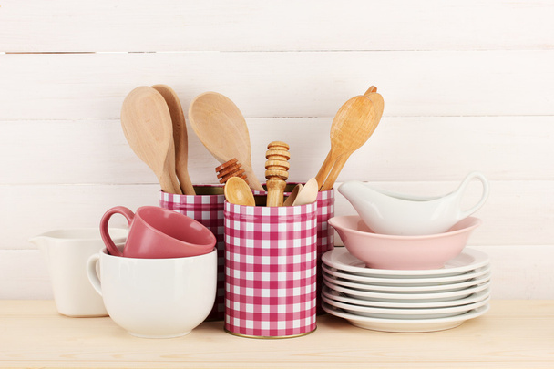 Cups, bowls nd other utensils in metal containers isolated on light background - Photo, image