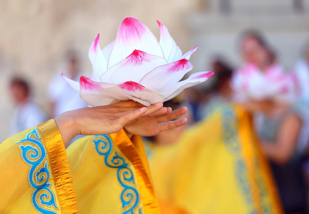 hand holds a blossomed lotus flower - Photo, Image