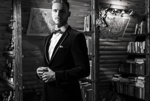 Handsome young elegant man pose against house interior. Black-white portrait. - Фото, зображення