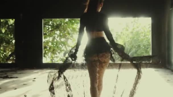 Beautiful woman in abandoned building / Back view of beautiful woman walking down in abandoned building and throwing away lace fabric  - video in slow motion - Footage, Video