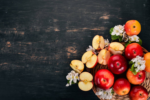 Fresh red apples with inflorescences and leaves. On a wooden background. Top view. Copy space. - Φωτογραφία, εικόνα