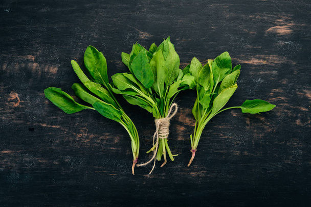 Green Fresh Spinach. On a wooden background. Healthy food. Top view. Copy space. - Фото, зображення