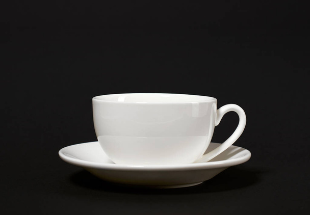 one simple coffee cup on black background, closeup photo - Photo, Image