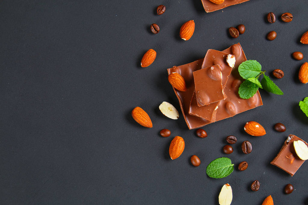 chocolate with almonds on dark grey background - Fotó, kép