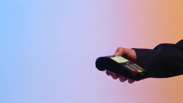 Close up of customer paying by credit card. Stock. Payment for purchase by Bank transfer on a colored background - Footage, Video