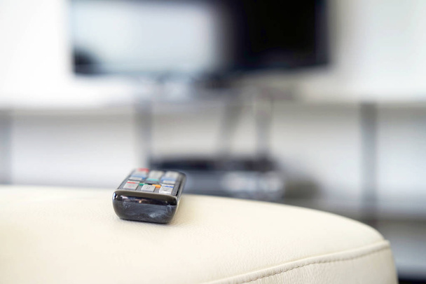 TV remote control on couch indoors, closeup. Home cinema - Foto, imagen