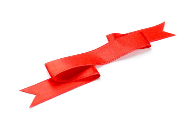 Simple red ribbon on white background. Festive decoration - 写真・画像