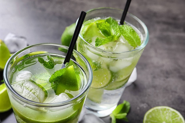 Refreshing beverage with mint and lime on table, closeup - Foto, afbeelding