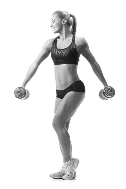 fitness nainen urheiluvaatteet tekee harjoituksia dumbells
. - Valokuva, kuva
