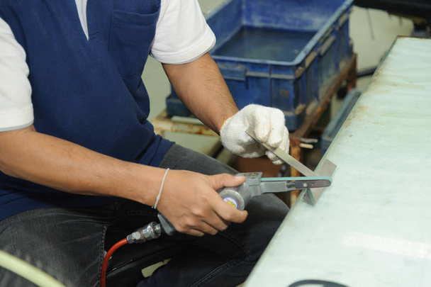 Trabajador que utiliza lijadora de cinturón de aire práctico. Máquina de lijadora de cinta neumática
 - Foto, imagen