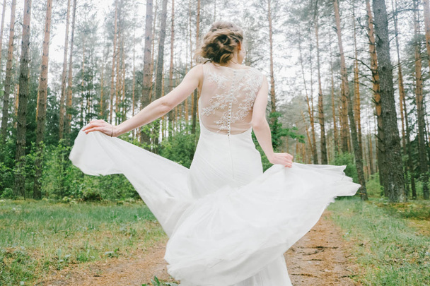 Young happy bride on her wedding day, details of wedding dress - 写真・画像