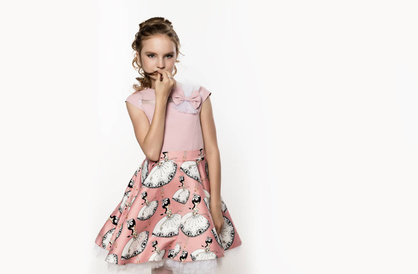 cute little girl in pink dress on white background. Children fashion, style concept. free space for text - Φωτογραφία, εικόνα