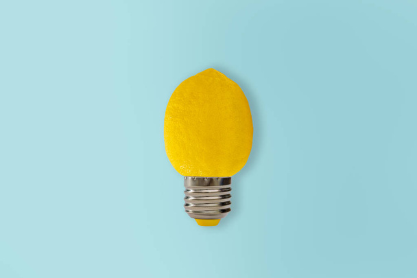 Yellow Lemon light bulb on bright blue background. Summer fun concept. - Foto, immagini