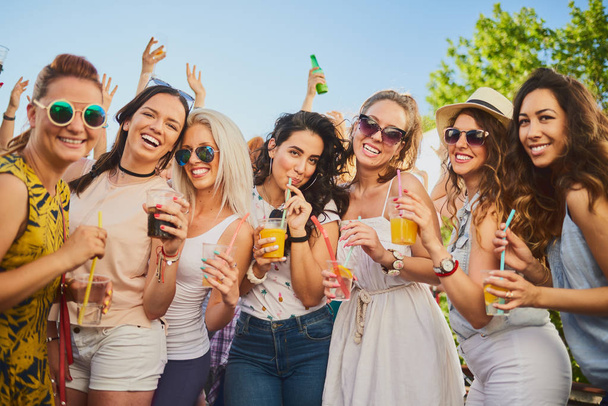 Group of female friends dancing and having a good time at the outdoor party/music festival  - Photo, Image