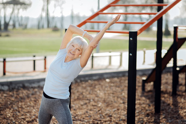Delighted athletic woman exercising outdoors - Valokuva, kuva