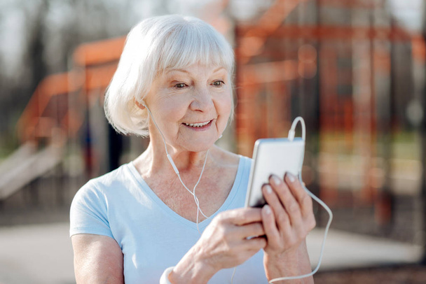 Delighted old woman listening to music - Φωτογραφία, εικόνα
