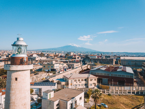 Amazing aerial Catania old town view from above with mighty Etna volcano on the background. - Fotó, kép