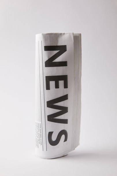 rolled daily newspaper on white background - Foto, Imagem