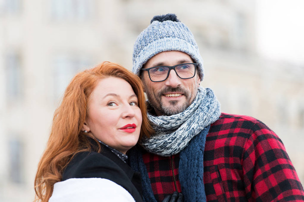 Sweet couple looking in different sides. Happy family look in other directions. Smiling woman and men in glasses like to look around. Portrait of romantic urban couple outdoor. Winter family portrait - Foto, immagini