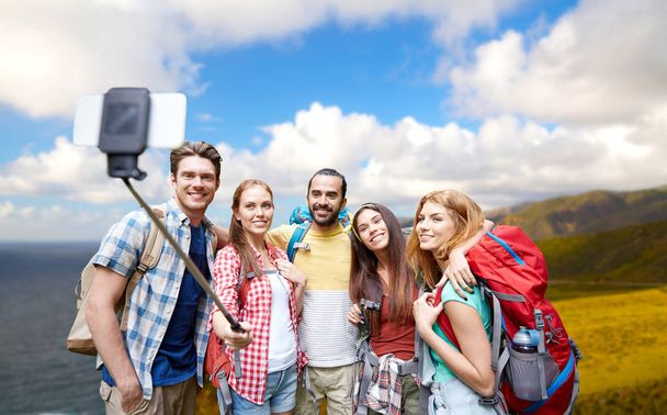 friends with backpacks taking selfie by smartphone - Fotografie, Obrázek