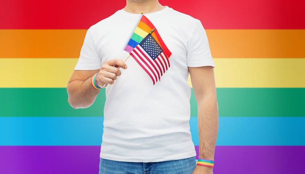 gay man with american flag and rainbow wristbands - Фото, изображение