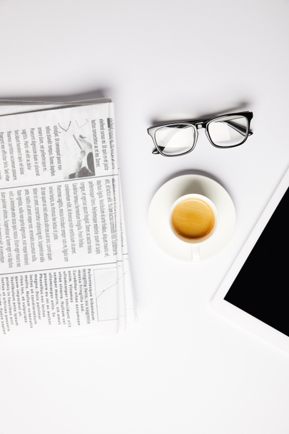 flat lay with eyeglasses, coffee, digital tablet and newspapers, on white - Photo, Image