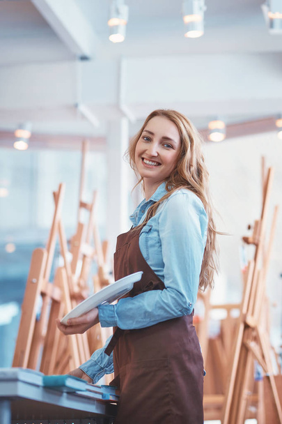 Happy young artist with easels indoors - Φωτογραφία, εικόνα