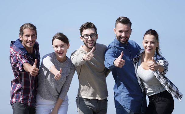 smiling group of young people showing thumb up. - Foto, Bild