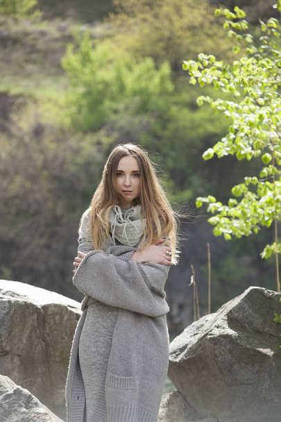 Beautiful girl in warm sweater on a natural background. - Valokuva, kuva