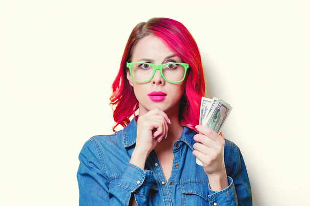 girl in blue shirt and glasses holding a money - Fotoğraf, Görsel