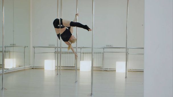 Female pole dancer, woman dancing on pylon in studio - Foto, Imagen