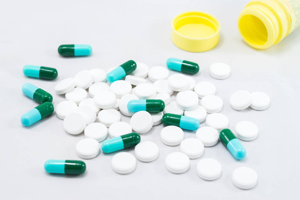 Medicamentos. Comprimidos e cápsulas sobre fundo branco
 - Foto, Imagem