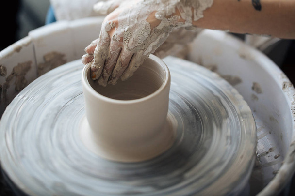 Handcrafted on a potter's wheel,Hands make clay from various items for home and sale in the store and at the exhibition, ceramic items are made in hand, the clay billet becomes a ceramic dish - Photo, Image