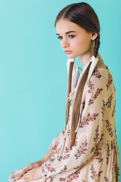beautiful elegant teen girl with braids, isolated on turquoise - Zdjęcie, obraz