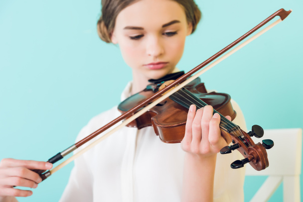 beautiful girl playing violin, isolated on blue - Φωτογραφία, εικόνα