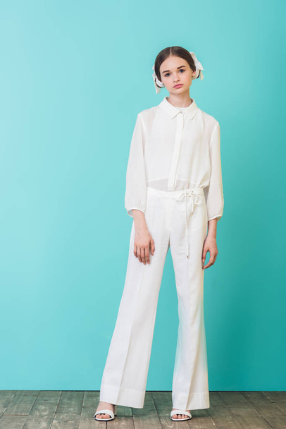 fashionable teen girl posing in white outfit on turquoise - Zdjęcie, obraz