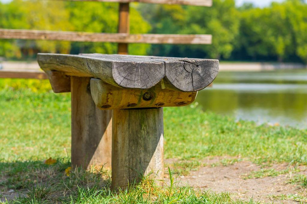 Wooden bench close to the lake shore - Photo, Image