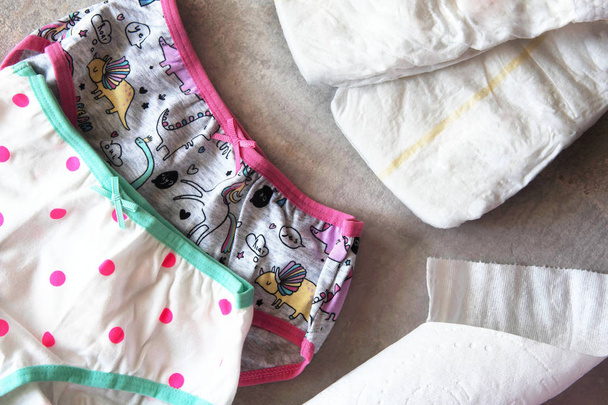 Toddler training on the pot, colorul panties and diapers. - Photo, Image