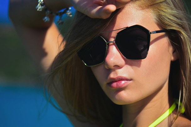 Closeup fashion beautiful woman portrait wearing sunglasses. Portrait of happy teenage girl in sunglasses. Summer lady - 写真・画像