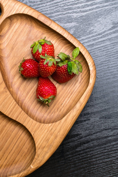 raw fresh strawberry in wooden background. Breakfast conception - 写真・画像