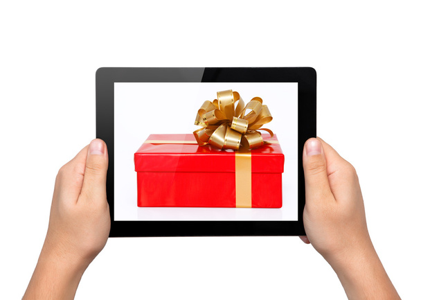 Men hands hold a tablet touch computer gadget with a gift - Foto, imagen